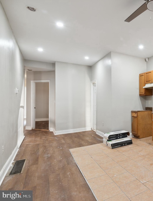 interior space featuring light wood-type flooring and ceiling fan