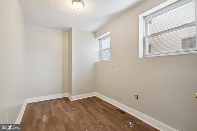 unfurnished room featuring dark hardwood / wood-style floors