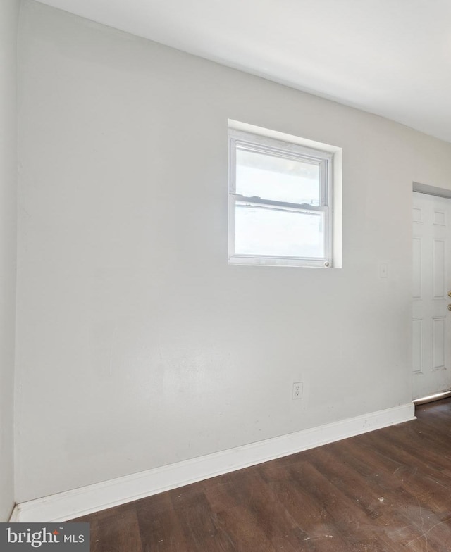 unfurnished room featuring dark hardwood / wood-style flooring