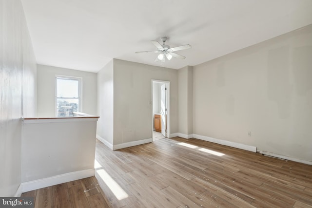 unfurnished room with light hardwood / wood-style floors and ceiling fan