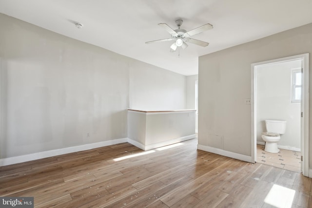 spare room with ceiling fan and light wood-type flooring