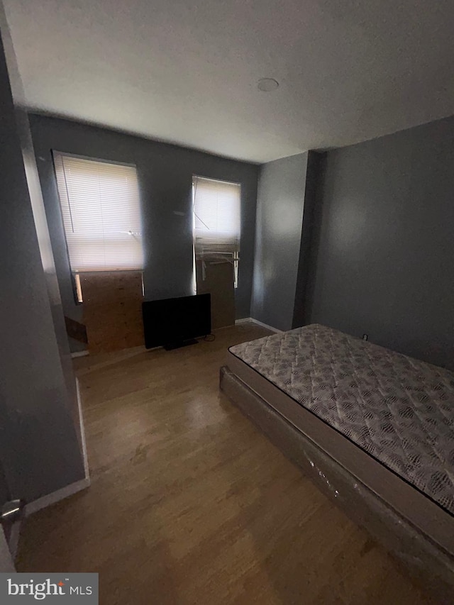 unfurnished bedroom with wood-type flooring