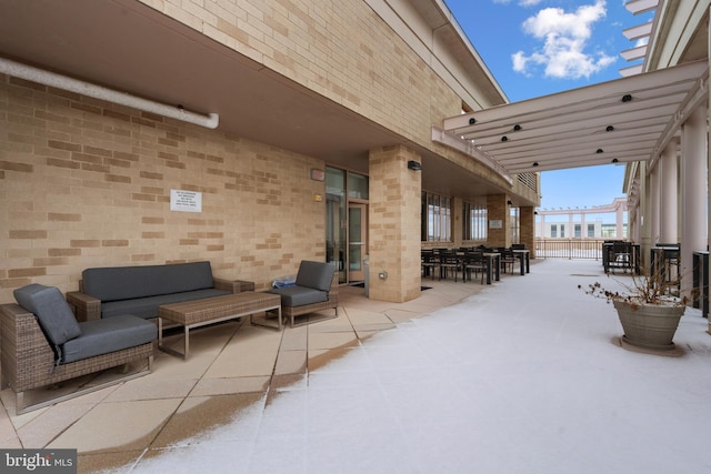 snow covered patio featuring an outdoor hangout area