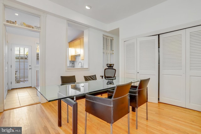 office area with light hardwood / wood-style floors and sink