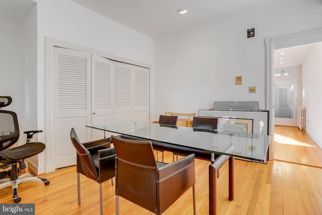 dining area featuring radiator and light hardwood / wood-style floors