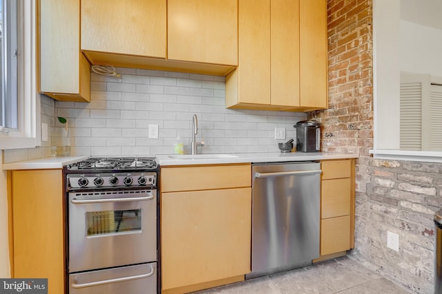 kitchen with tasteful backsplash, light brown cabinetry, sink, and stainless steel appliances