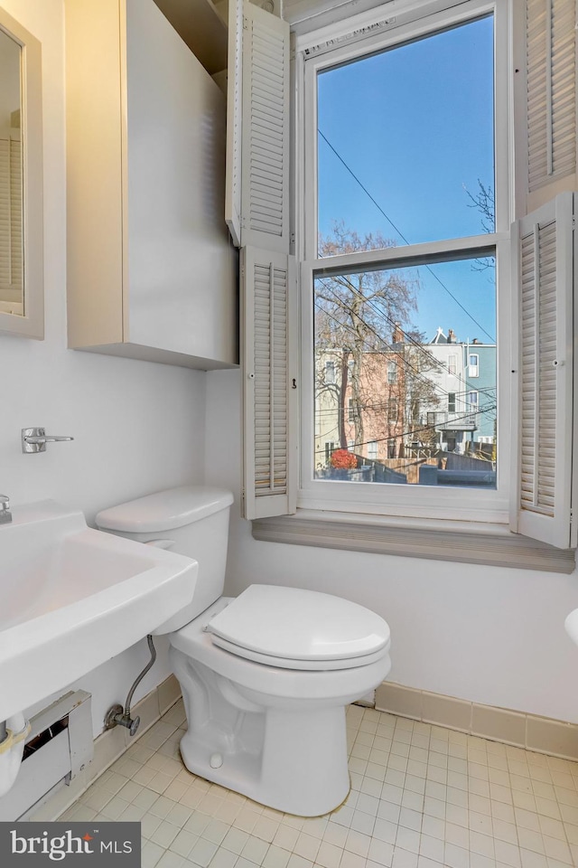 136 E St SE, Washington, DC 20003 - half bathroom featuring toilet and tile patterned floors