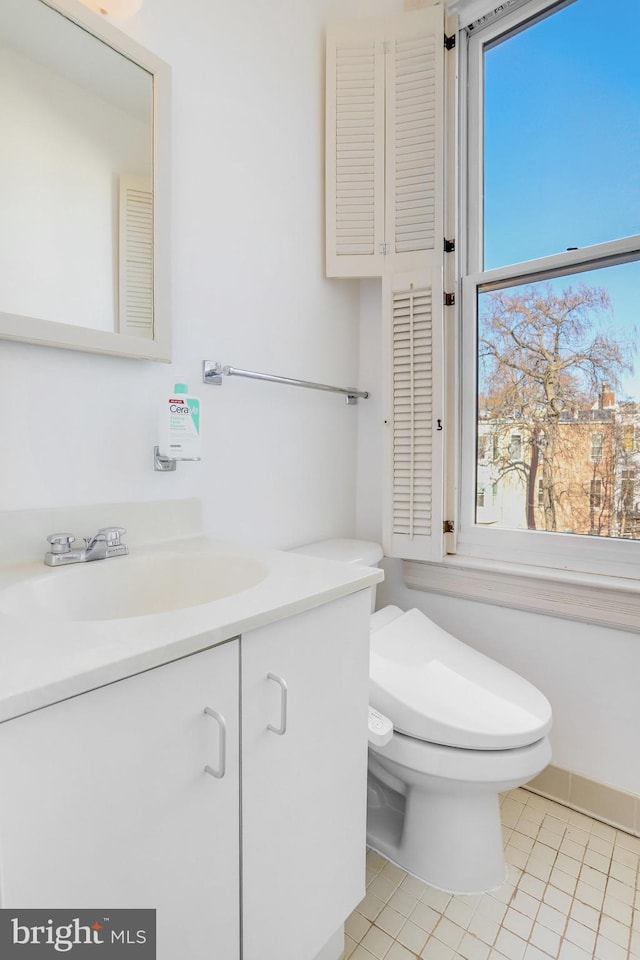 bathroom with tile patterned floors, vanity, and toilet