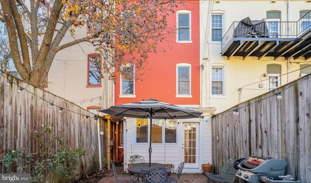 back of property featuring a balcony