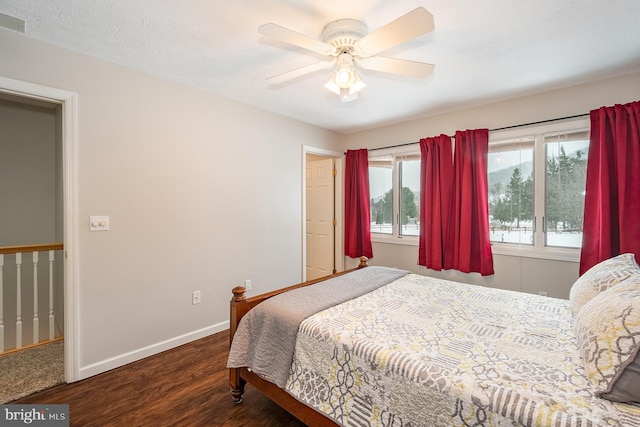 bedroom featuring a textured ceiling, dark hardwood / wood-style flooring, and ceiling fan