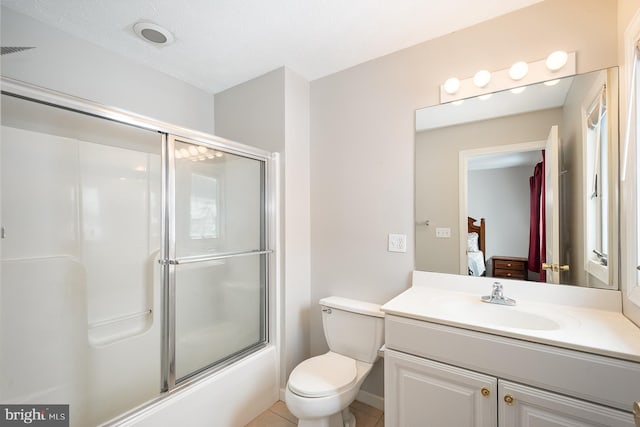 full bathroom featuring tile patterned floors, a textured ceiling, combined bath / shower with glass door, toilet, and vanity