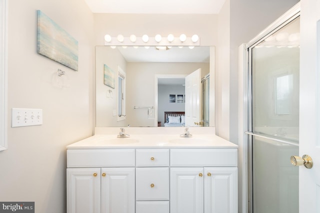 bathroom featuring vanity and a shower with shower door