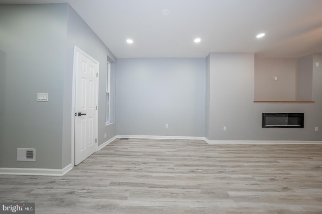 interior space with light wood-type flooring and heating unit