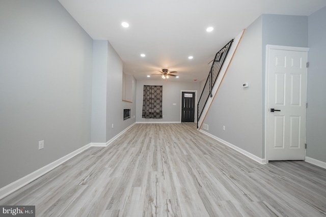 unfurnished living room featuring light hardwood / wood-style flooring and ceiling fan