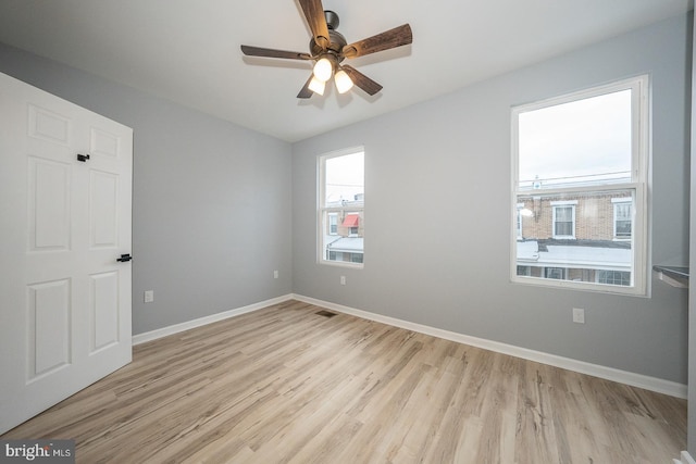 unfurnished room with light hardwood / wood-style floors and ceiling fan