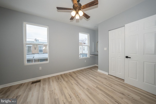 unfurnished bedroom featuring ceiling fan, a closet, and light hardwood / wood-style floors