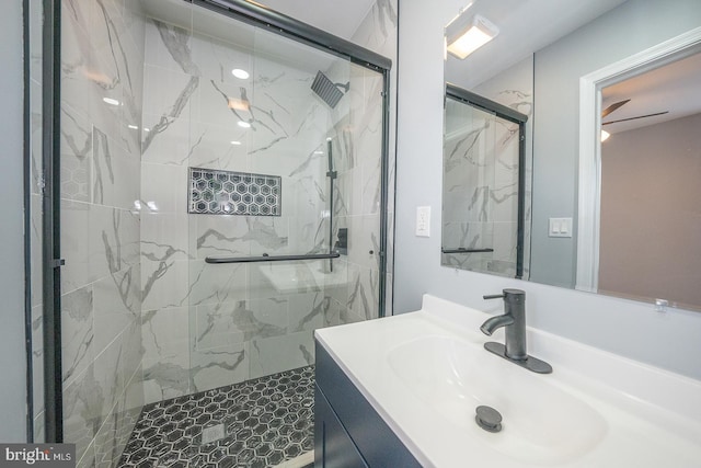 bathroom with vanity and a shower with shower door