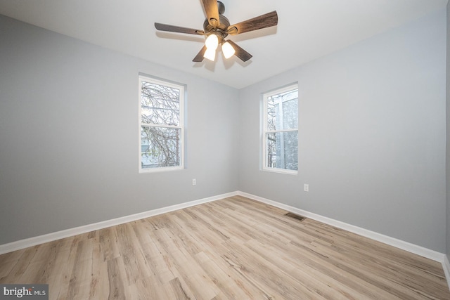 unfurnished room with ceiling fan, plenty of natural light, and light hardwood / wood-style flooring