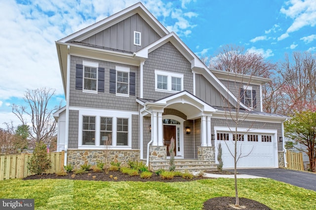 craftsman-style house with a front yard and a garage