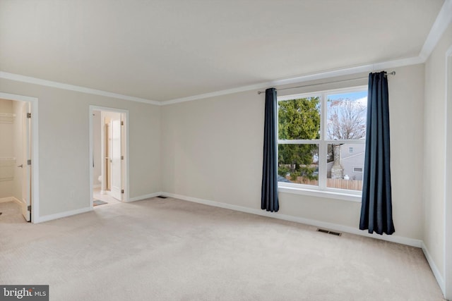 empty room featuring light colored carpet and ornamental molding