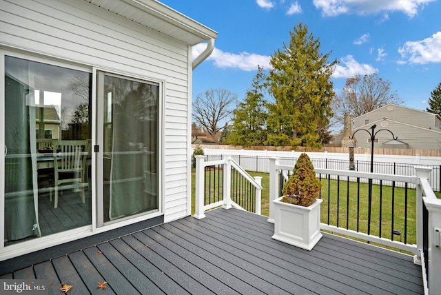 wooden terrace featuring a yard