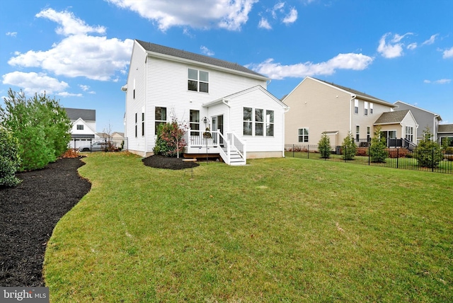 back of house featuring a deck and a yard