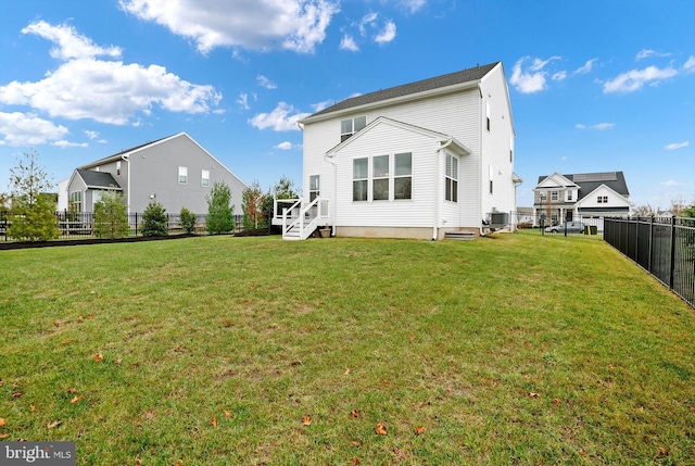 rear view of house with a lawn