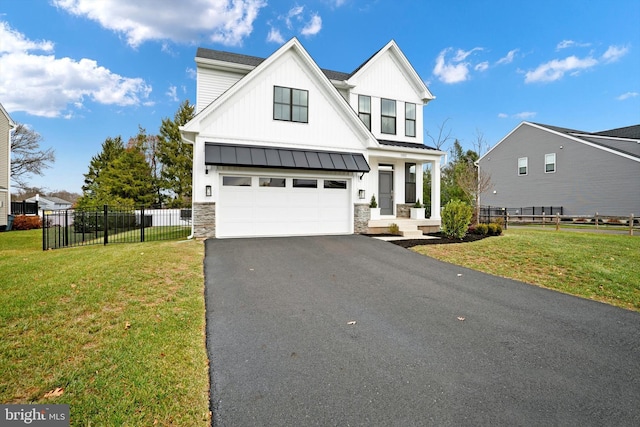 view of front of house with a garage and a front lawn