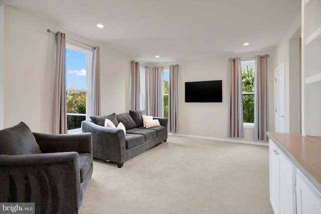 carpeted living room with a healthy amount of sunlight