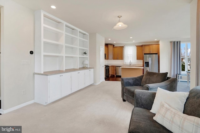 living room with light carpet and sink