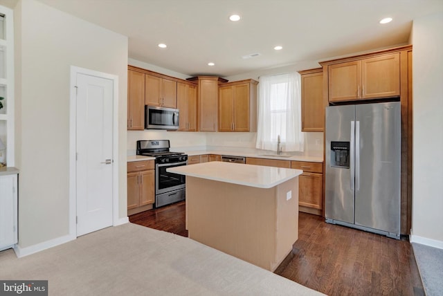 kitchen with a kitchen island, sink, stainless steel appliances, and dark wood-type flooring