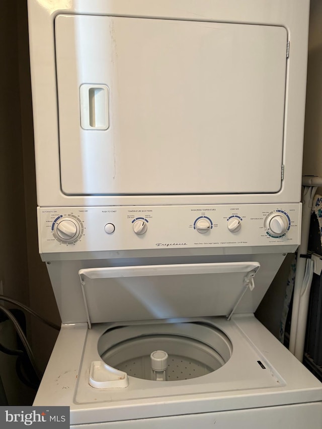 clothes washing area featuring stacked washer / dryer