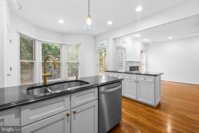 kitchen featuring gray cabinetry, dishwasher, sink, hanging light fixtures, and dark hardwood / wood-style flooring