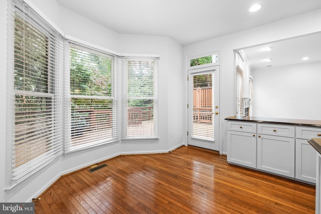 unfurnished dining area with wood-type flooring