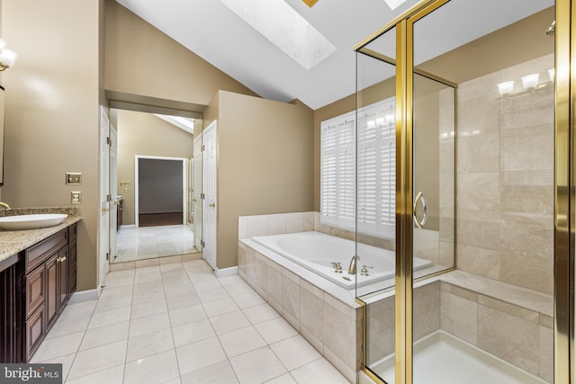 bathroom with separate shower and tub, vaulted ceiling with skylight, vanity, and tile patterned flooring