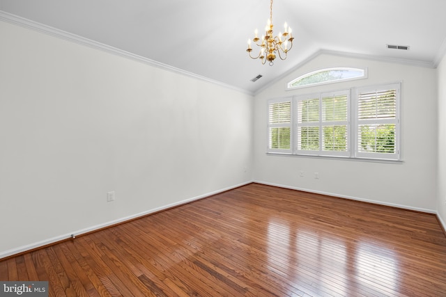 unfurnished room with hardwood / wood-style floors, vaulted ceiling, an inviting chandelier, and ornamental molding