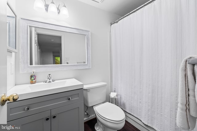 bathroom with vanity, toilet, and wood-type flooring