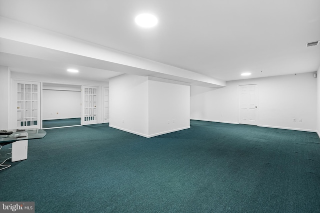 basement with dark colored carpet and french doors