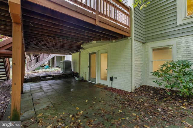 view of patio / terrace with a wooden deck and central AC unit