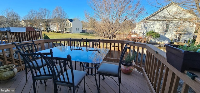 wooden deck with a lawn