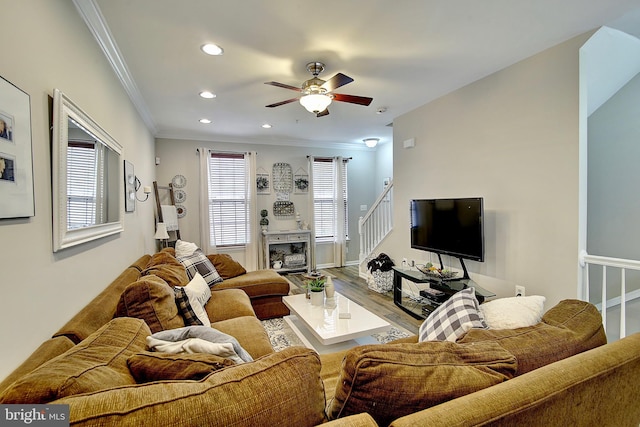 living room featuring crown molding, ceiling fan, and hardwood / wood-style flooring