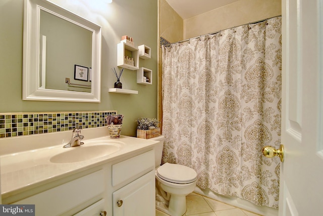 bathroom featuring tile patterned flooring, vanity, and toilet