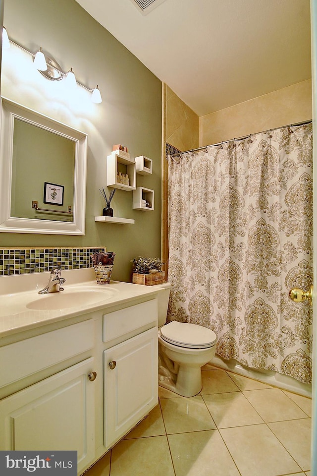 bathroom with tile patterned floors, vanity, a shower with shower curtain, and toilet