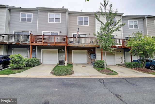 view of front of property featuring central AC unit and a garage