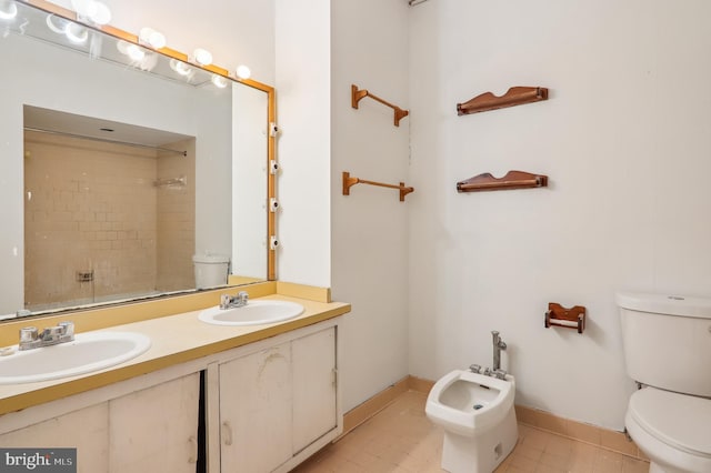 bathroom featuring a tile shower, tile patterned flooring, a bidet, toilet, and vanity