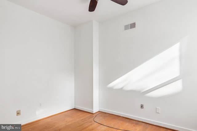 spare room with hardwood / wood-style flooring and ceiling fan