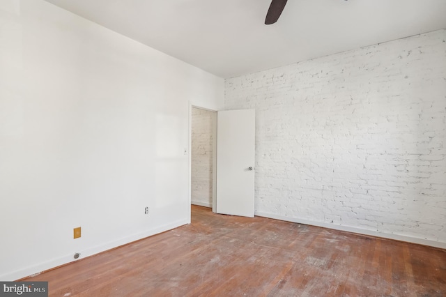 empty room featuring ceiling fan and hardwood / wood-style floors