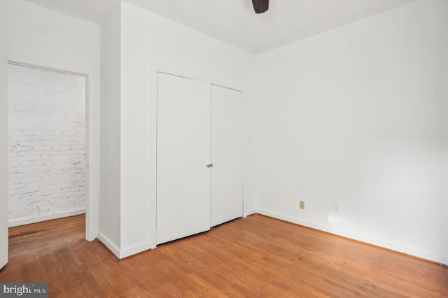 unfurnished bedroom with ceiling fan and hardwood / wood-style flooring