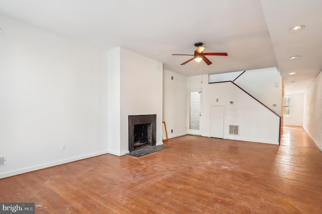 unfurnished living room with ceiling fan and hardwood / wood-style flooring