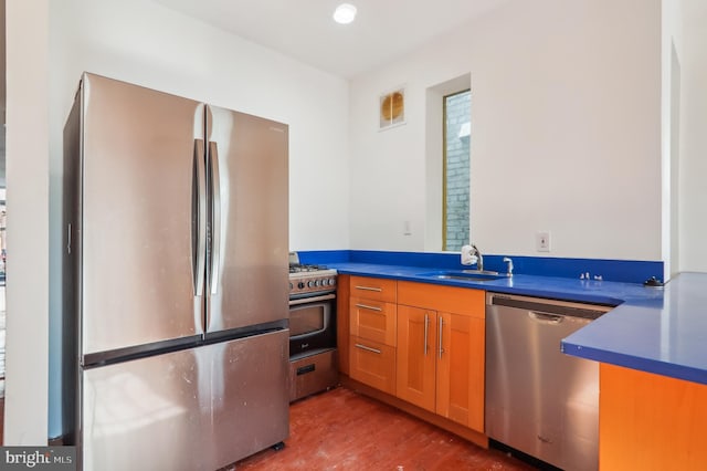 kitchen with sink, hardwood / wood-style floors, and appliances with stainless steel finishes